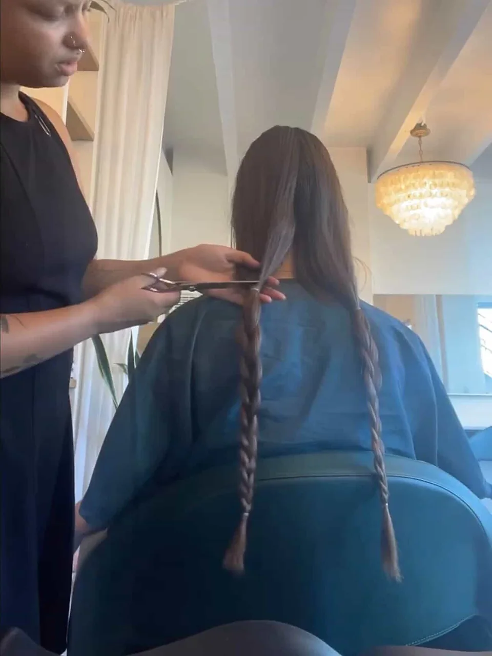 Before: waist-length hair sectioned into two long braids, scissors mid-cut.