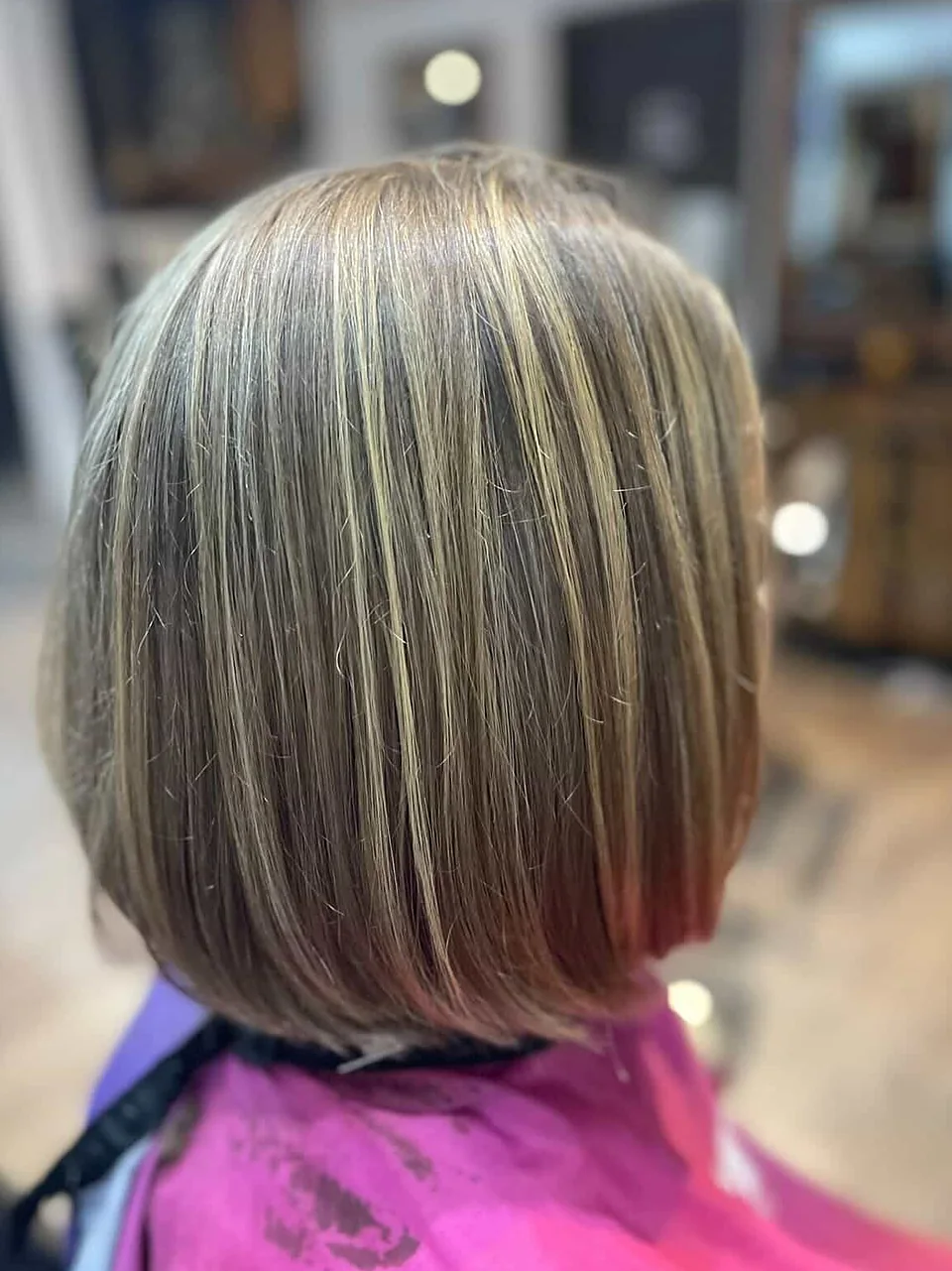 After: a chin-length bob threaded with bright dimensional foils.