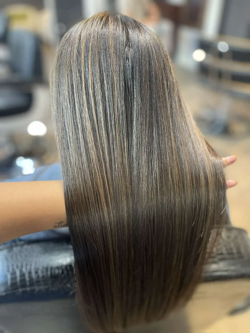 Cool ash highlights running through long brunette hair.