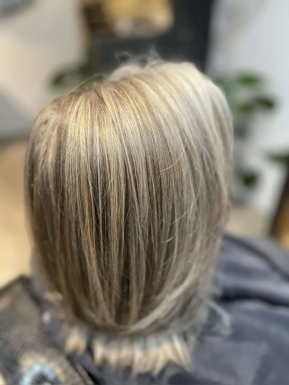 Blonde highlights through straightened shoulder-length hair.