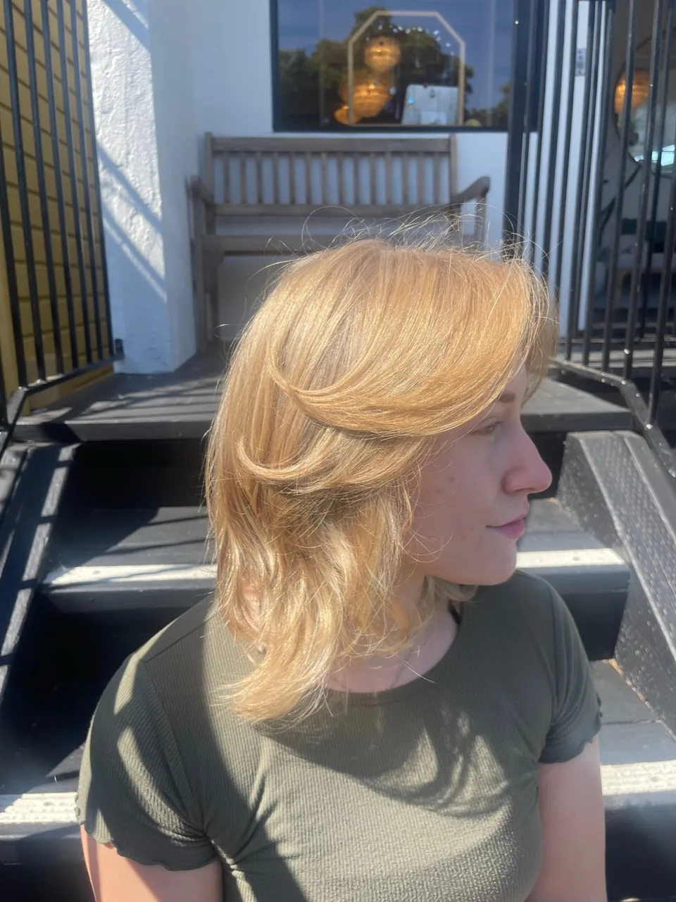 A blonde shag cut with heavy layers and a fringe.