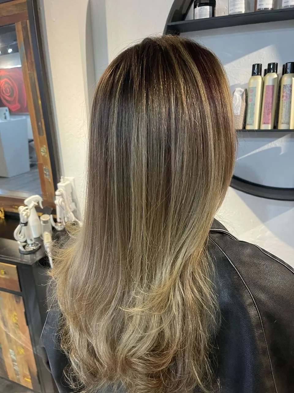 A dark root melting down into bronde balayage on long layers.