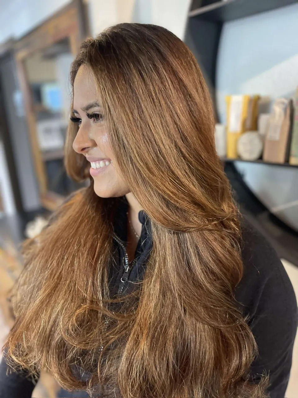 Long caramel balayage with a soft wave through the lengths.