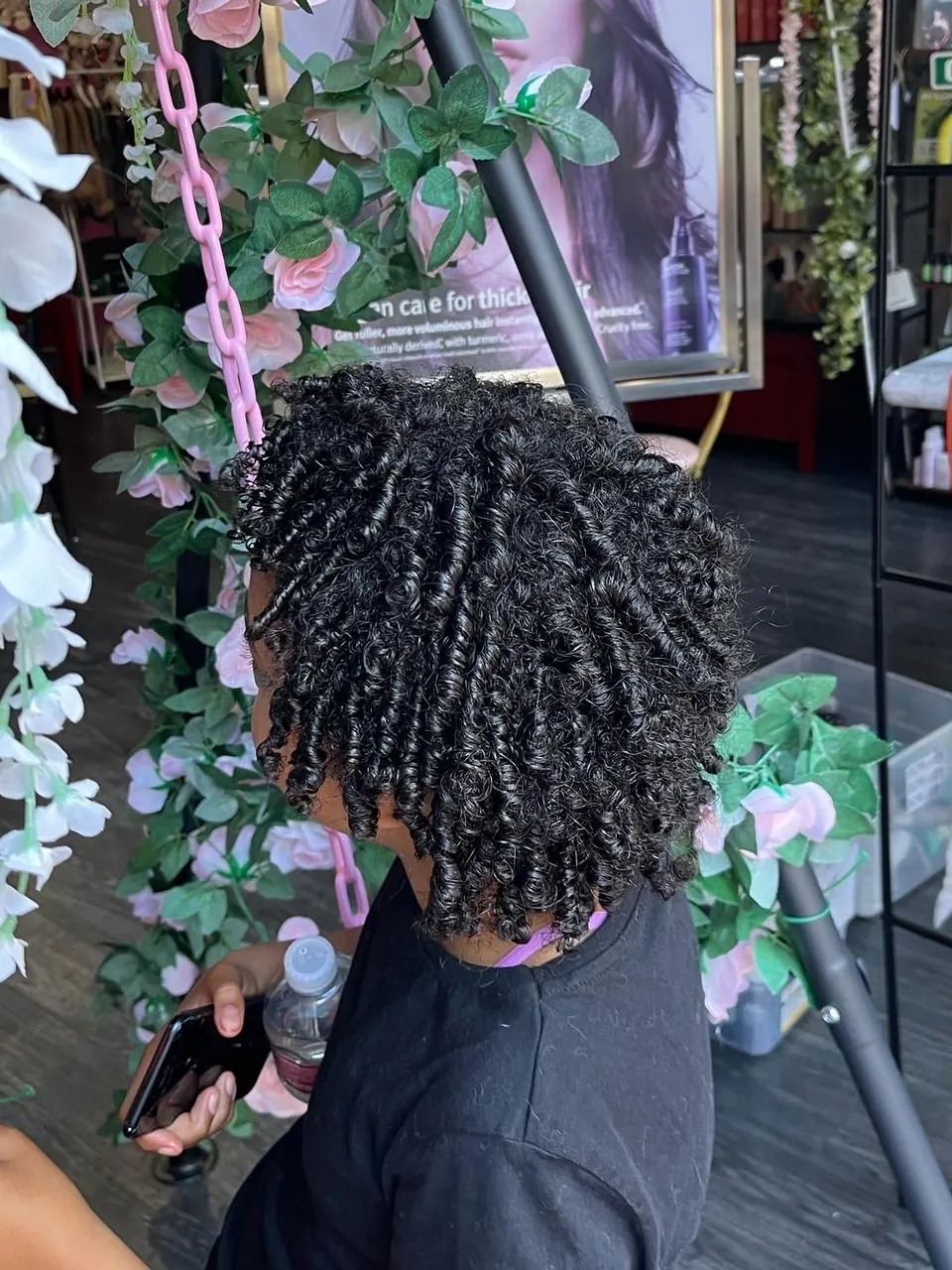 A defined coil set on natural hair, spiral coils shaped through the length.