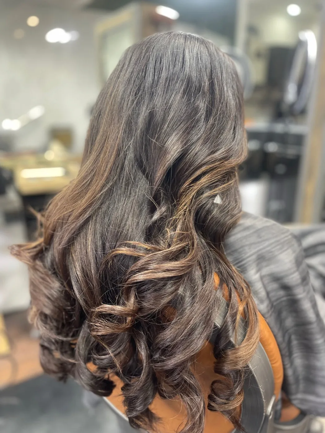Dark spiral curls shaped into a rounded silhouette.