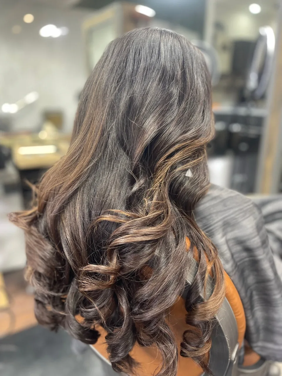Dark spiral curls shaped into a rounded silhouette.