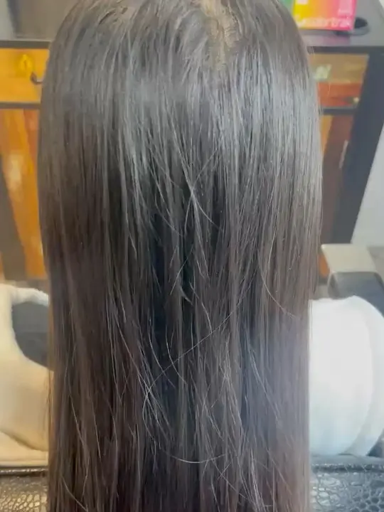 Long dark brunette hair finished with a high-shine gloss.