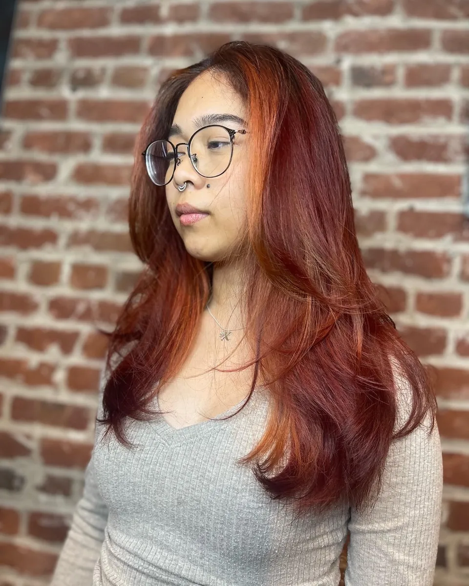 Long copper-red hair, photographed from behind.