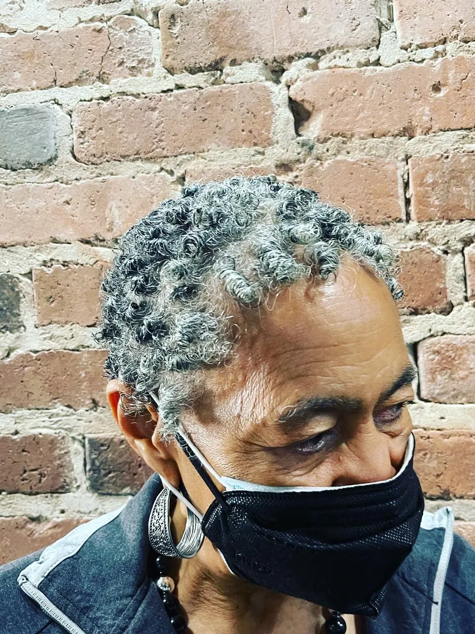Short silver coils shaped close to the head.